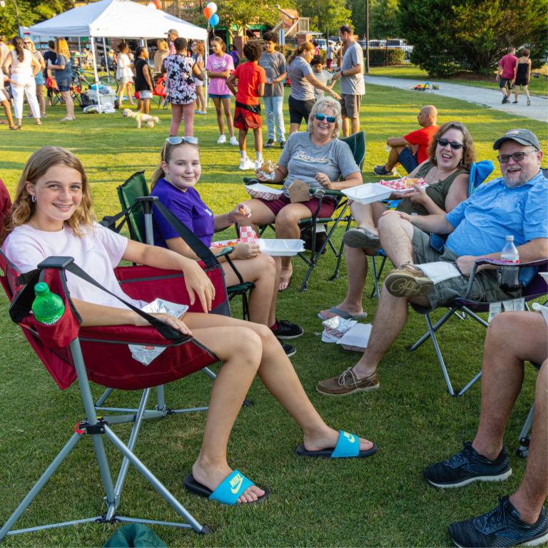 people sitting in chairs in Lilburn City Park