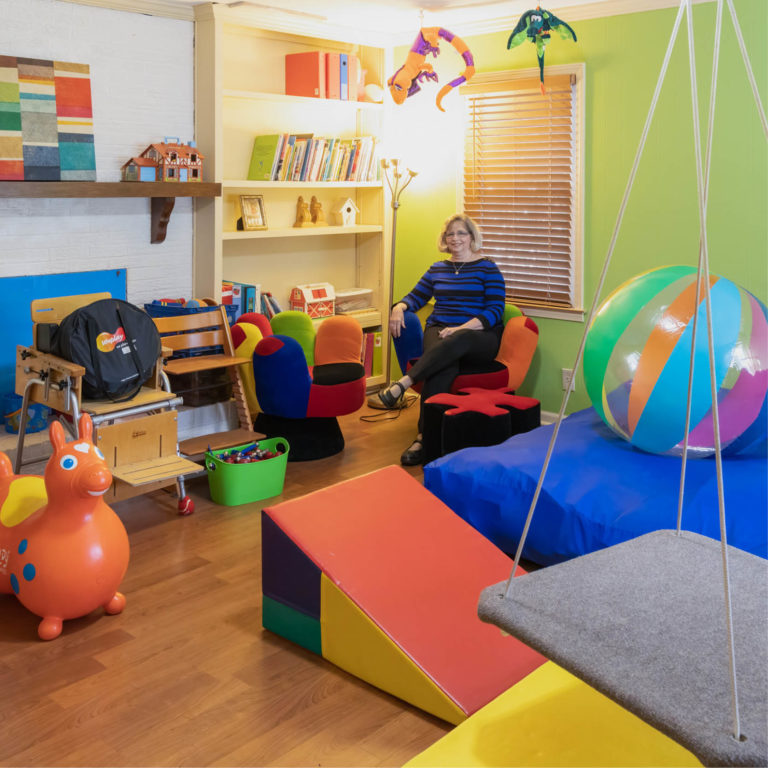interior image of learning clinic with woman sitting and fun furniture